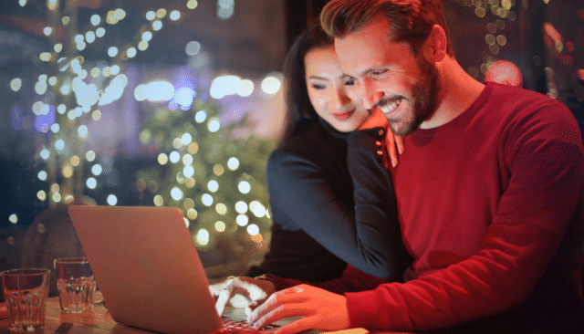 man and woman christmas shopping online