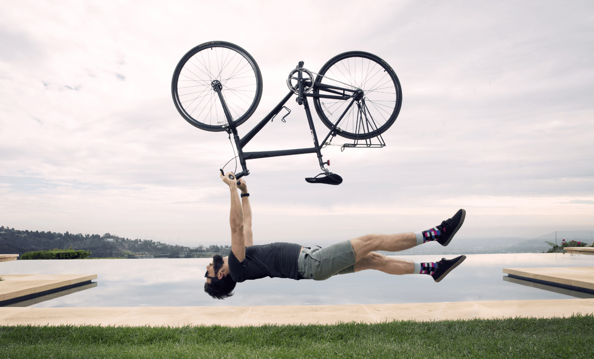 Man with bike upside down