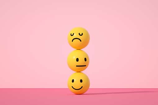 3d rendering of emoji with smiley, sad and neutral face on pink color background.