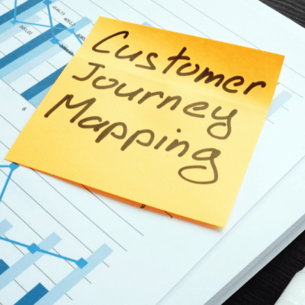 Customer Journey Mapping words on yellow sticky note - to understand merchandising