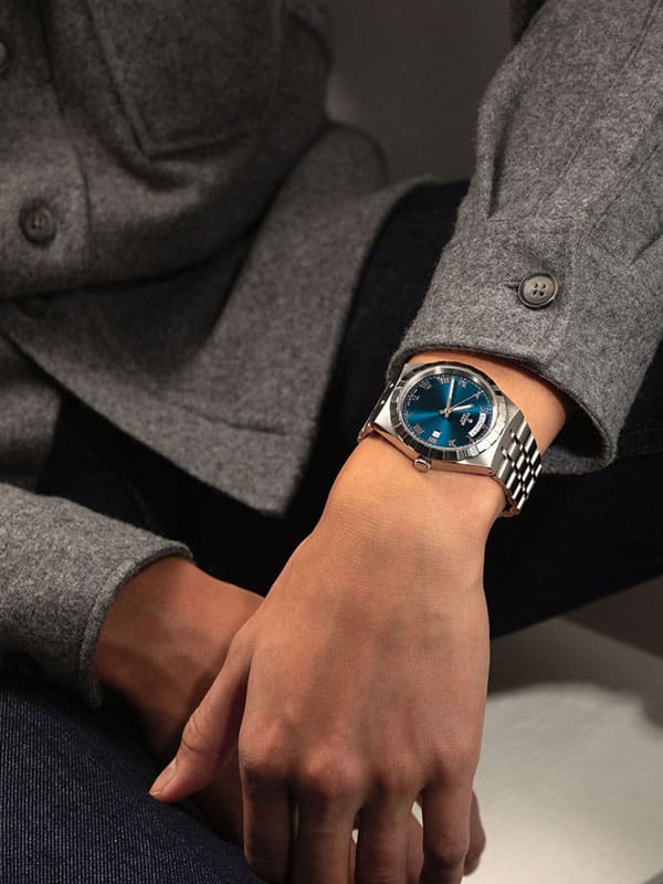 Lux Bond & Green image_ man wearing a silver wrist watch