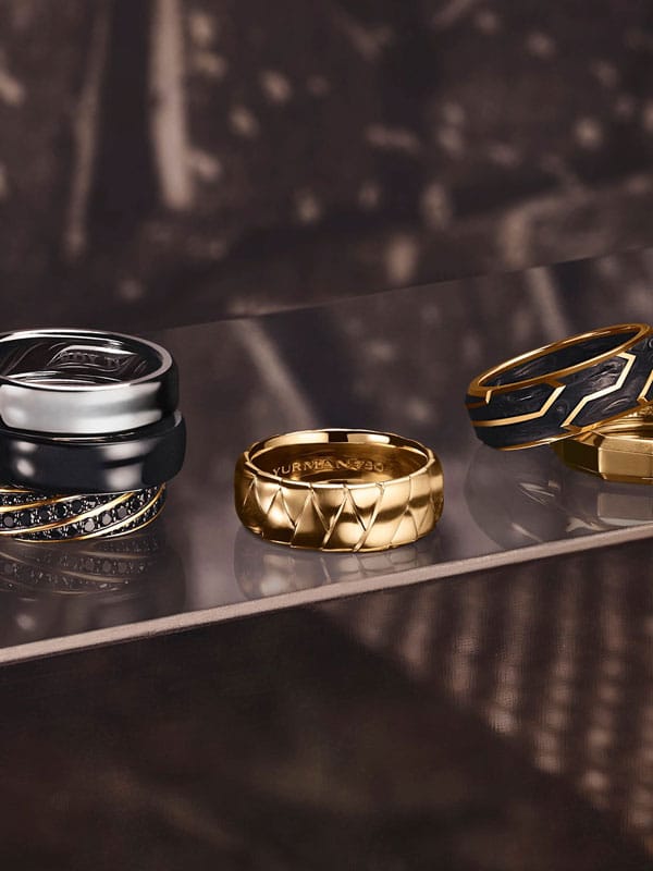 Stylized image of a gold ring, silver ring, and black ring