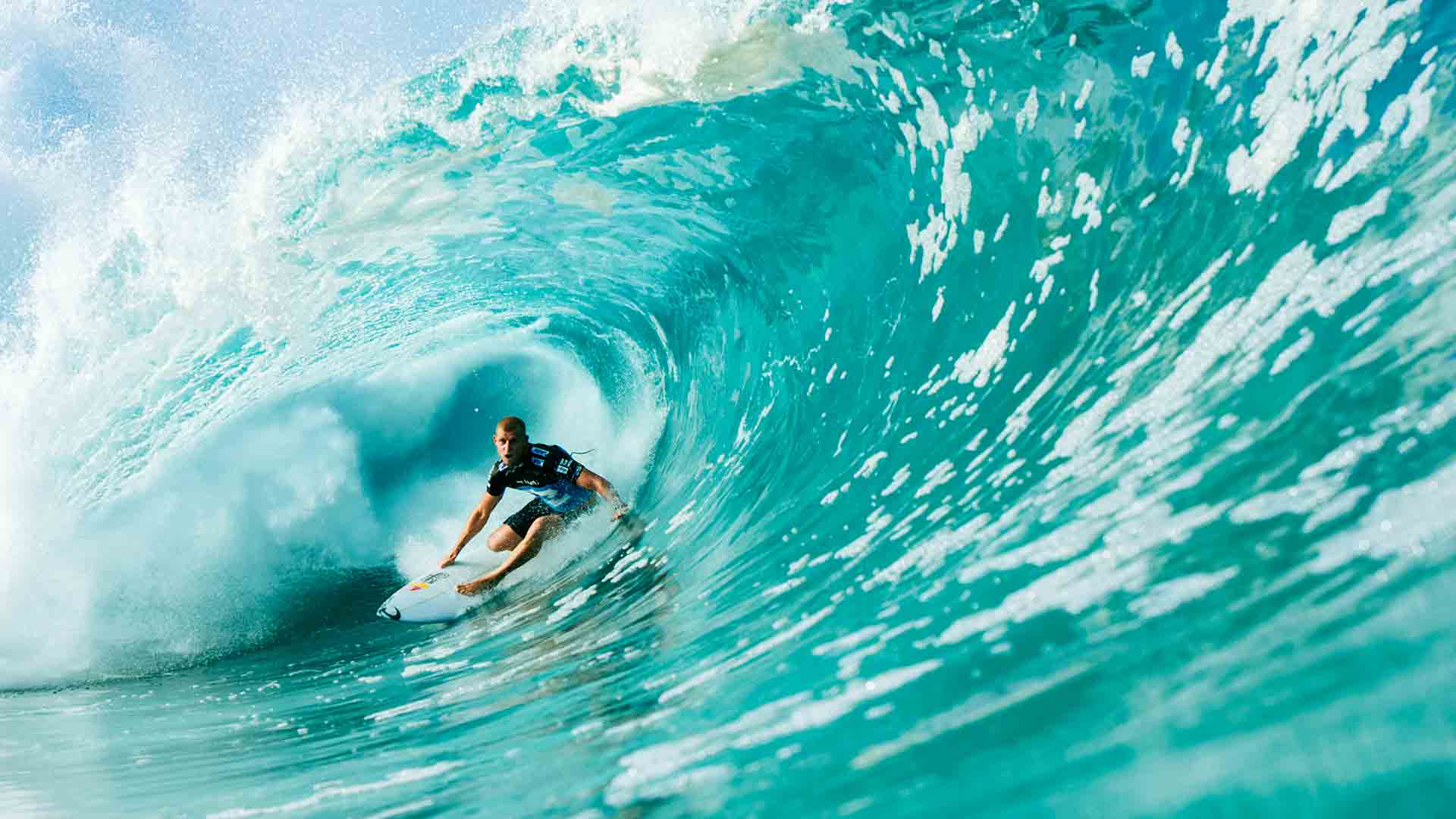 male surfer in the middle of a large wave